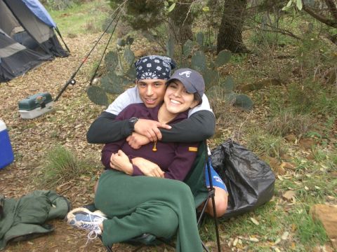 1994 Ford Bronco - A couple enjoys a camping trip together, with a tent and fishing equipment in the background.