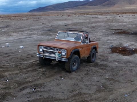 1969 Ford Bronco - A classic Ford Bronco sits in a barren, outdoor environment under a cloudy sky.