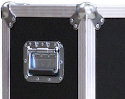 1994 Ford Bronco - Close-up photograph of a road/flight case corner showing a chrome recessed latch and metal corner pieces.