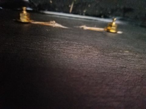 1994 Ford Bronco - Out-of-focus photograph of gold binding-post terminals mounted on a carpeted speaker enclosure.