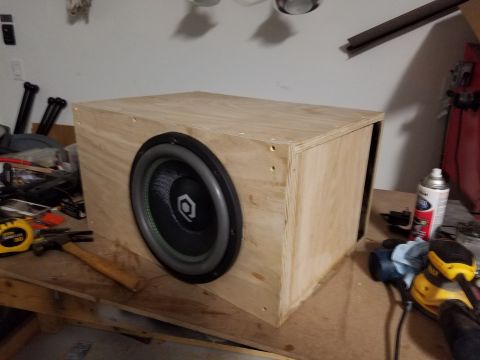1994 Ford Bronco - Photograph of a finished plywood subwoofer enclosure with the driver installed on a workbench.