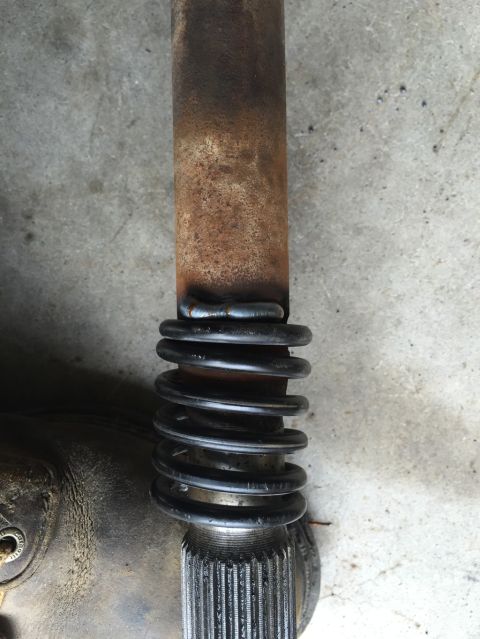 1984 Ford Bronco - Close-up of a driveshaft a spring and splined end, with visible weld marks.