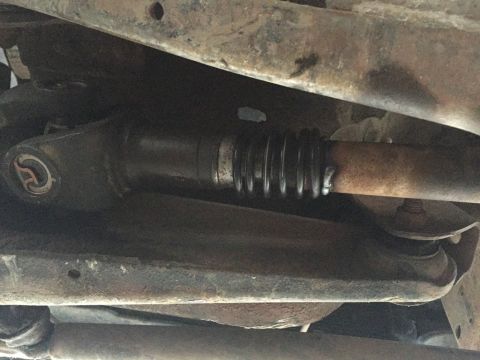 1984 Ford Bronco - Underside view of a driveshaft U-joint and protective boot.