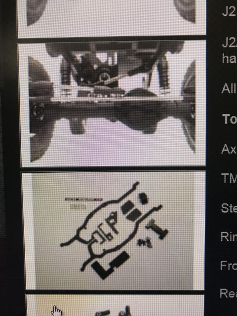 1989 Ford Bronco - Close-up of a vehicle's undercarriage, showing suspension and drivetrain parts.