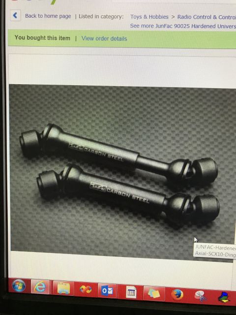 1989 Ford Bronco - Two black driveshafts, labeled "CARBON STEEL", are shown in a close-up view.