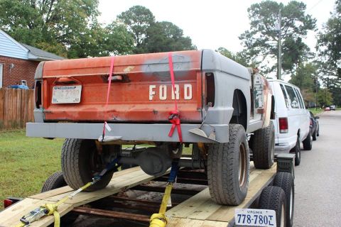 1966 Ford Bronco - This 1966 Ford Bronco is being transported on a trailer, showing its rear end with visible Ford branding.