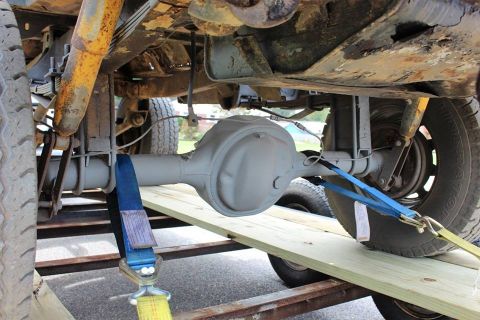1966 Ford Bronco - Vehicle's rear differential and suspension components are visible, strapped down on a trailer.