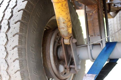 1966 Ford Bronco - This image shows the rear suspension components of a vehicle, including the tire, shock, and leaf springs.