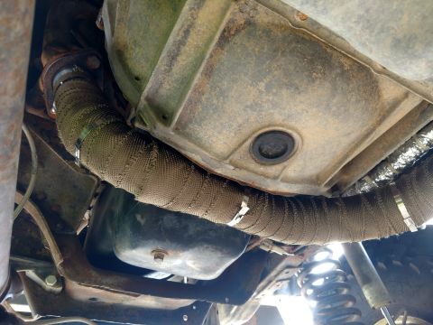 1992 Ford Bronco - Exhaust pipe wrap visible on the undercarriage of a vehicle.