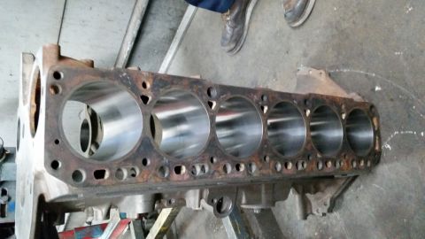 1981 Ford Bronco - A disassembled engine block with visible cylinder bores and mounting points.
