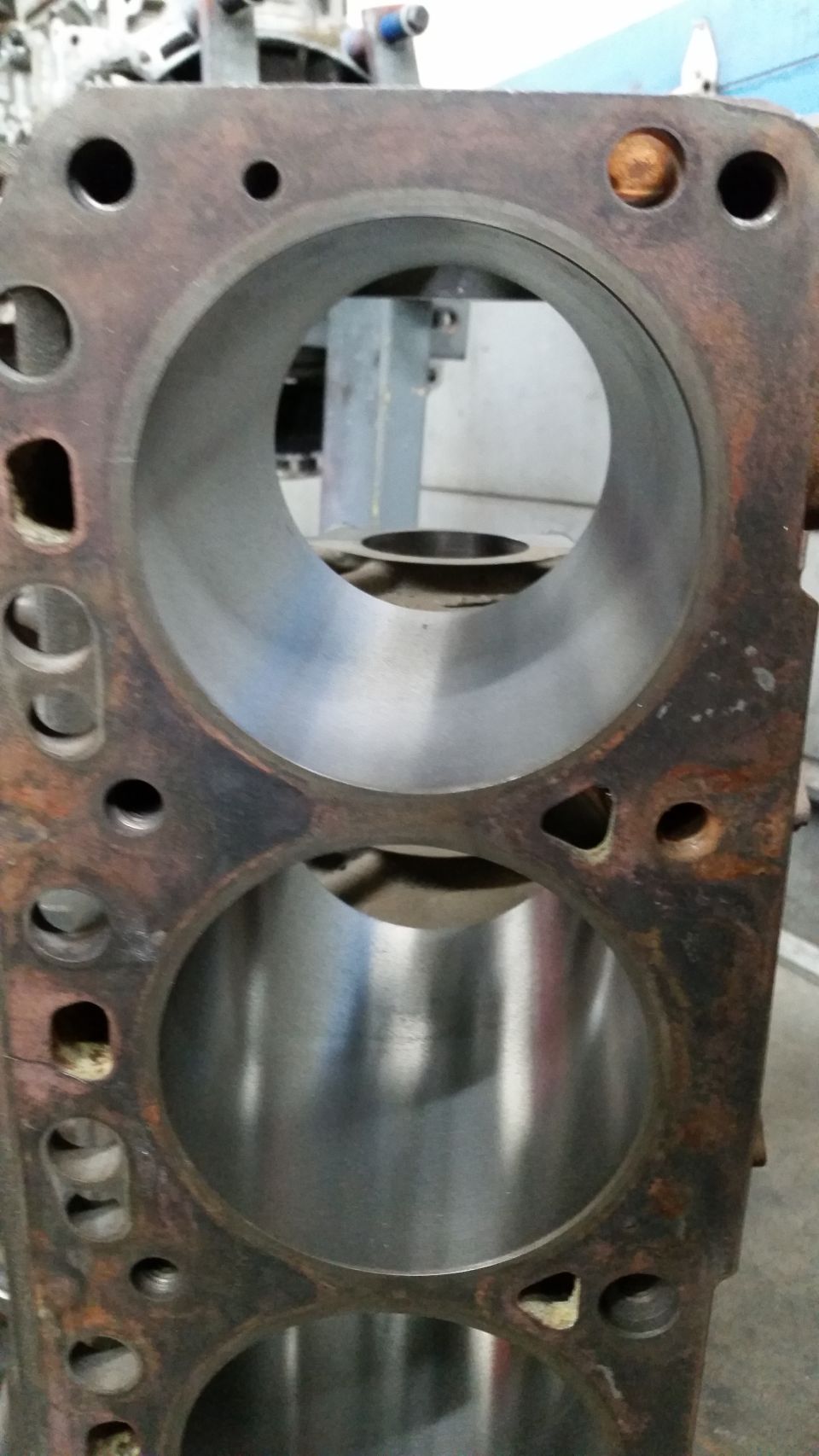 close-up of engine block cylinders, some rust visible