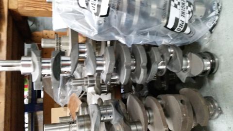 1981 Ford Bronco - Multiple crankshafts are visible, some still in protective plastic wrapping, suggesting they are new or recently serviced engine components.