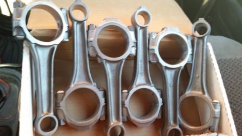 1981 Ford Bronco - A collection of six connecting rods, likely for an engine rebuild, are neatly arranged in a cardboard box.