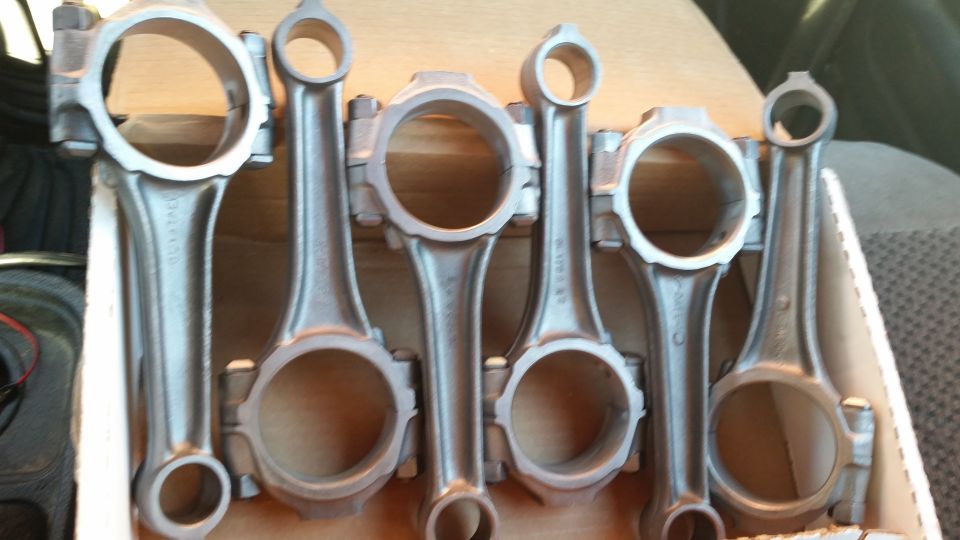 Set of six metal connecting rods in a box