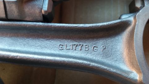 1981 Ford Bronco - Close-up of an engine connecting rod showing the stamped part number GL177B G P.