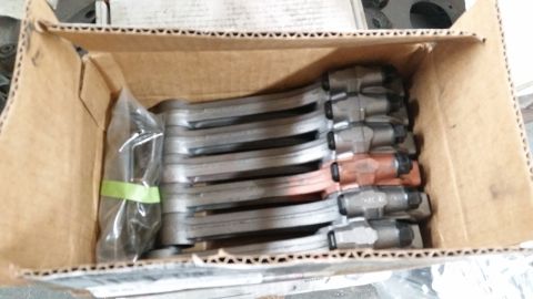 1981 Ford Bronco - A box contains multiple connecting rods, some with copper-colored bearings.