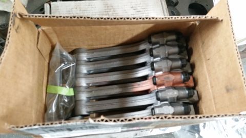 1981 Ford Bronco - A box containing multiple brake calipers, some showing copper-colored pistons.
