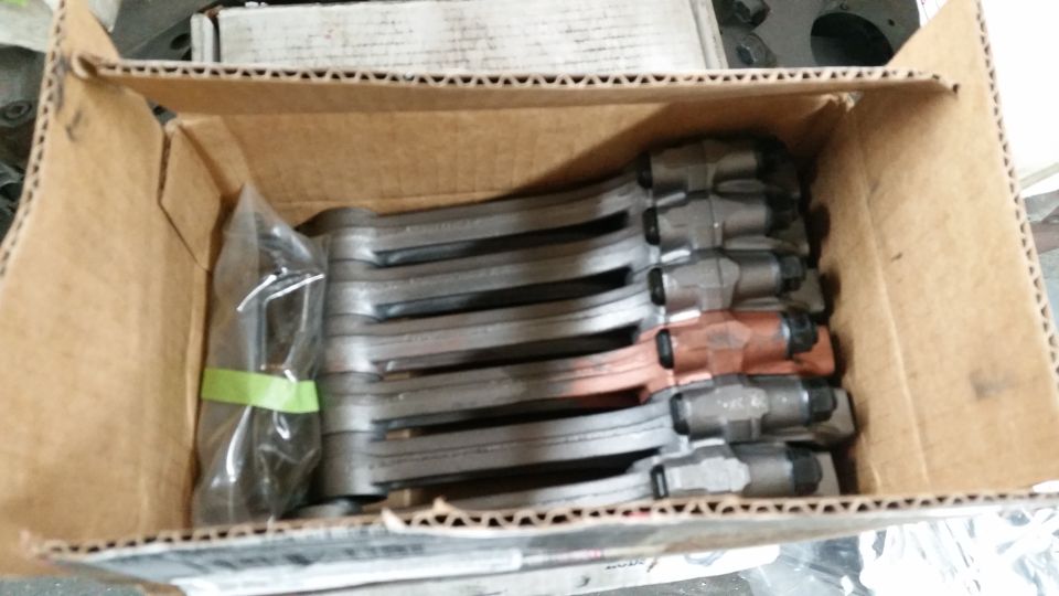 Box of brake calipers, some with copper-colored pistons
