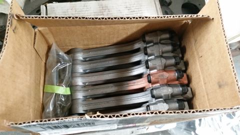 1981 Ford Bronco - A box contains multiple engine connecting rods, some individually wrapped in plastic.