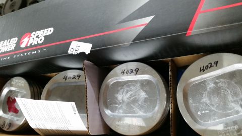 1981 Ford Bronco - Pistons from Speed Pro engine systems are shown in their packaging.