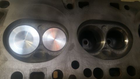 1981 Ford Bronco - Close-up of an engine cylinder head showing intake and exhaust valve seats.