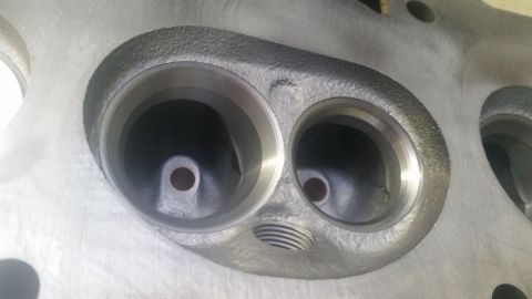 1981 Ford Bronco - This image shows a close-up view of an engine cylinder head, two prominent ports.
