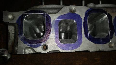 1981 Ford Bronco - Close-up of an engine cylinder head showing intake ports prepared for porting and polishing.
