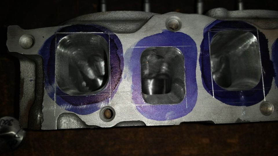 Engine cylinder head with intake ports marked for modification
