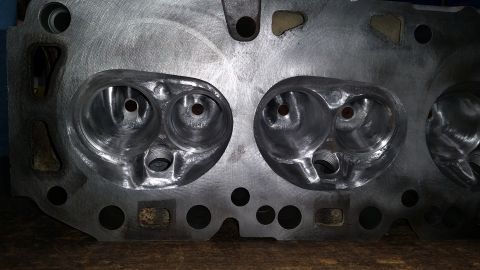 1981 Ford Bronco - This is a close-up view of a metal engine cylinder head, showing the intake and exhaust ports.