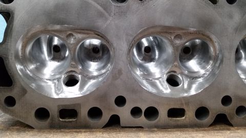 1981 Ford Bronco - Close-up of an engine cylinder head, revealing its internal structure and machined surfaces.