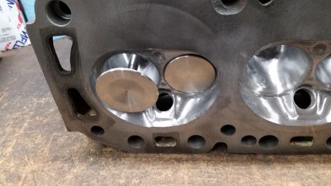 1981 Ford Bronco - Close-up view of an engine cylinder head, showing the intake and exhaust valves.