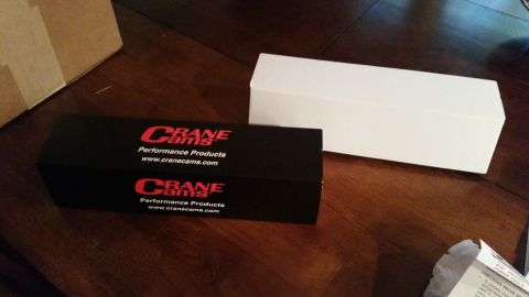 1981 Ford Bronco - A black box labeled "CRANE Cams Performance Products" sits on a wooden table next to a white box.