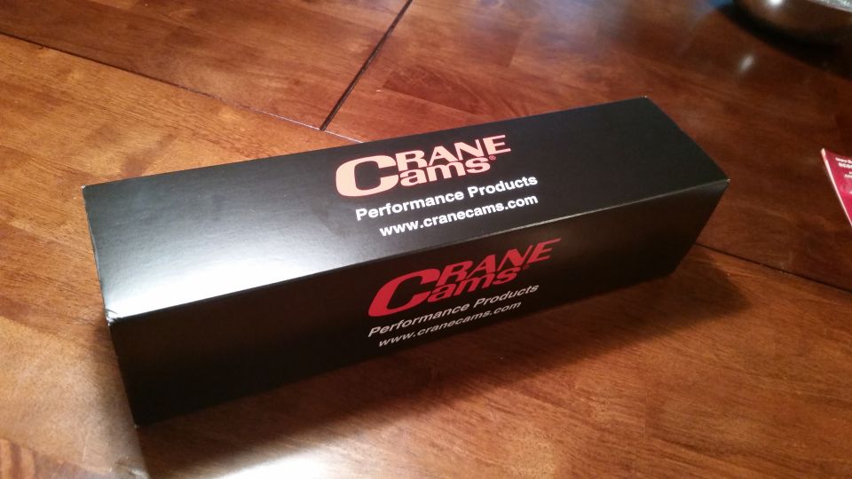 Black box with Crane Cams logo and website address on a wooden surface