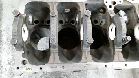 1981 Ford Bronco - This is a close-up, overhead view of the crankshaft bearing journals and main bearing caps of a V8 engine block. Some of the bearing caps a…