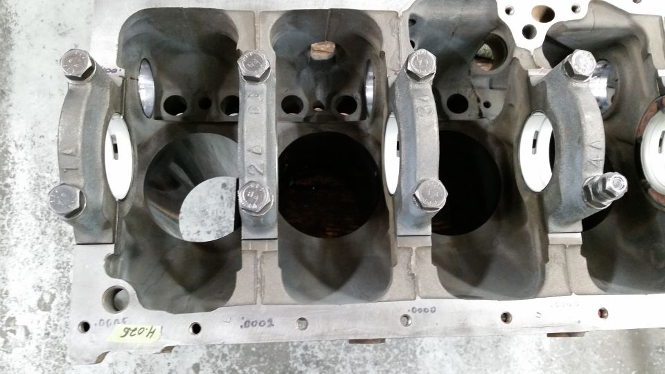Overhead view of V8 engine block crankshaft bearing journals and main bearing caps.