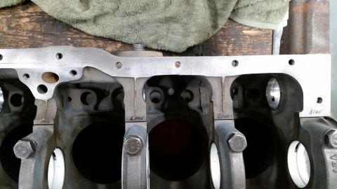 1981 Ford Bronco - Close-up view of the internal components of a V8 engine block, showing the crankshaft bearing caps and machined surfaces. Markings like "10…