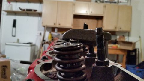 1981 Ford Bronco - Close-up view of the valve train components on a red engine block. Several valve springs and rocker arms are visible.