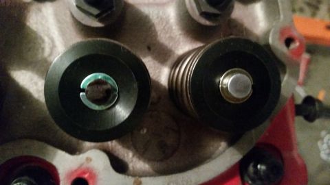 1981 Ford Bronco - A close-up view shows two black valve spring retainers on what appears to be an engine cylinder head. The retainer on the left has a visibl…