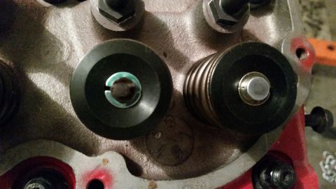 1981 Ford Bronco - A close-up view of two valve springs and retainers on an engine cylinder head. The engine block is painted red and appears to be made of ca…