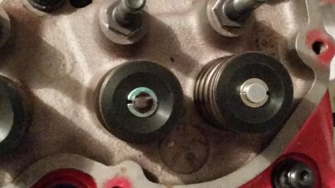 1981 Ford Bronco - A close-up view of two valve springs and retainers on what appears to be an engine cylinder head. The components are made of metal and have…