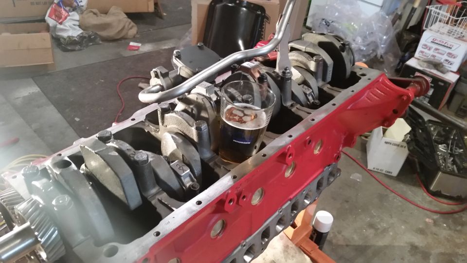 Engine block with crankshaft and a glass of beer