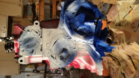 1981 Ford Bronco - A partially painted engine block is covered in blue and red masking tape. Text written on the block reads "COL'R 7.03".