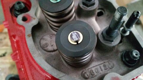 1981 Ford Bronco - A close-up view of the top of a red engine block, showing valve springs and retainers. Visible text on the block reads "60120".