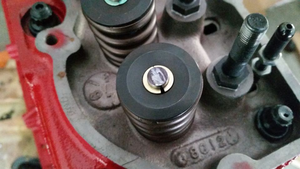 Close-up of engine block with valve springs and retainers, text "60120" visible.