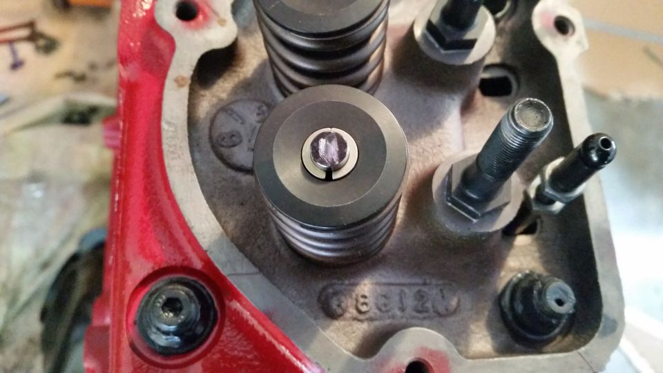 Close-up of engine block with valve springs and casting numbers.