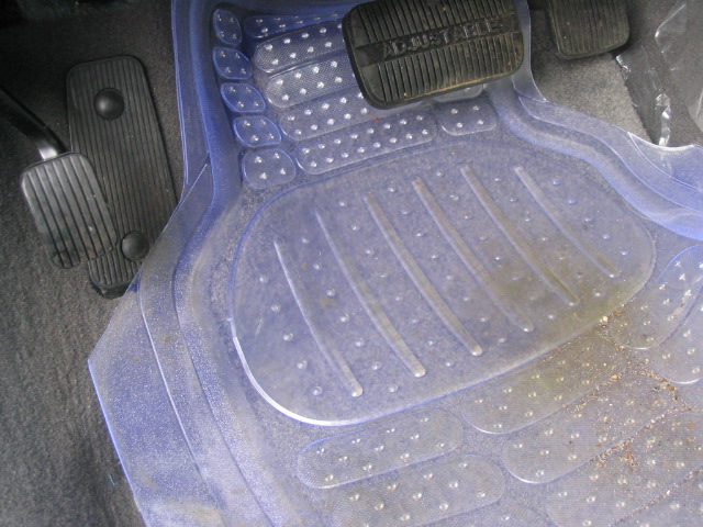 Clear floor mats with textured pedals visible