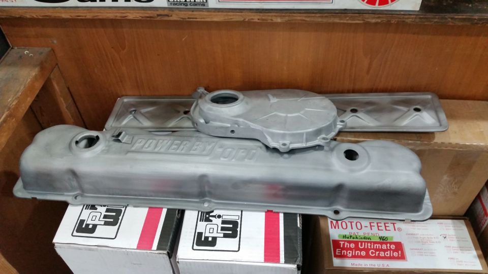 Two unpainted aluminum valve covers and a timing cover with "POWER BY FORD" text.