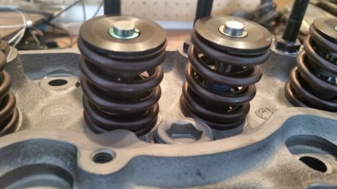1981 Ford Bronco - Close-up view of the valve springs and retainers on a gray engine cylinder head. The engine appears to be part of a Ford Bronco build.