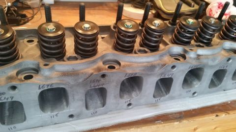 1981 Ford Bronco - A close-up view of an aluminum engine cylinder head with valve springs installed. Handwritten measurements are visible on the intake ports.