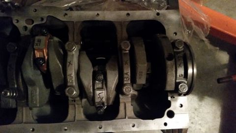 1981 Ford Bronco - This is a close-up view of the crankshaft and connecting rods inside an engine block. Several connecting rods are visible, each with markin…